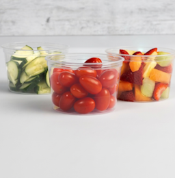 person closing a plastic container of sliced peppers