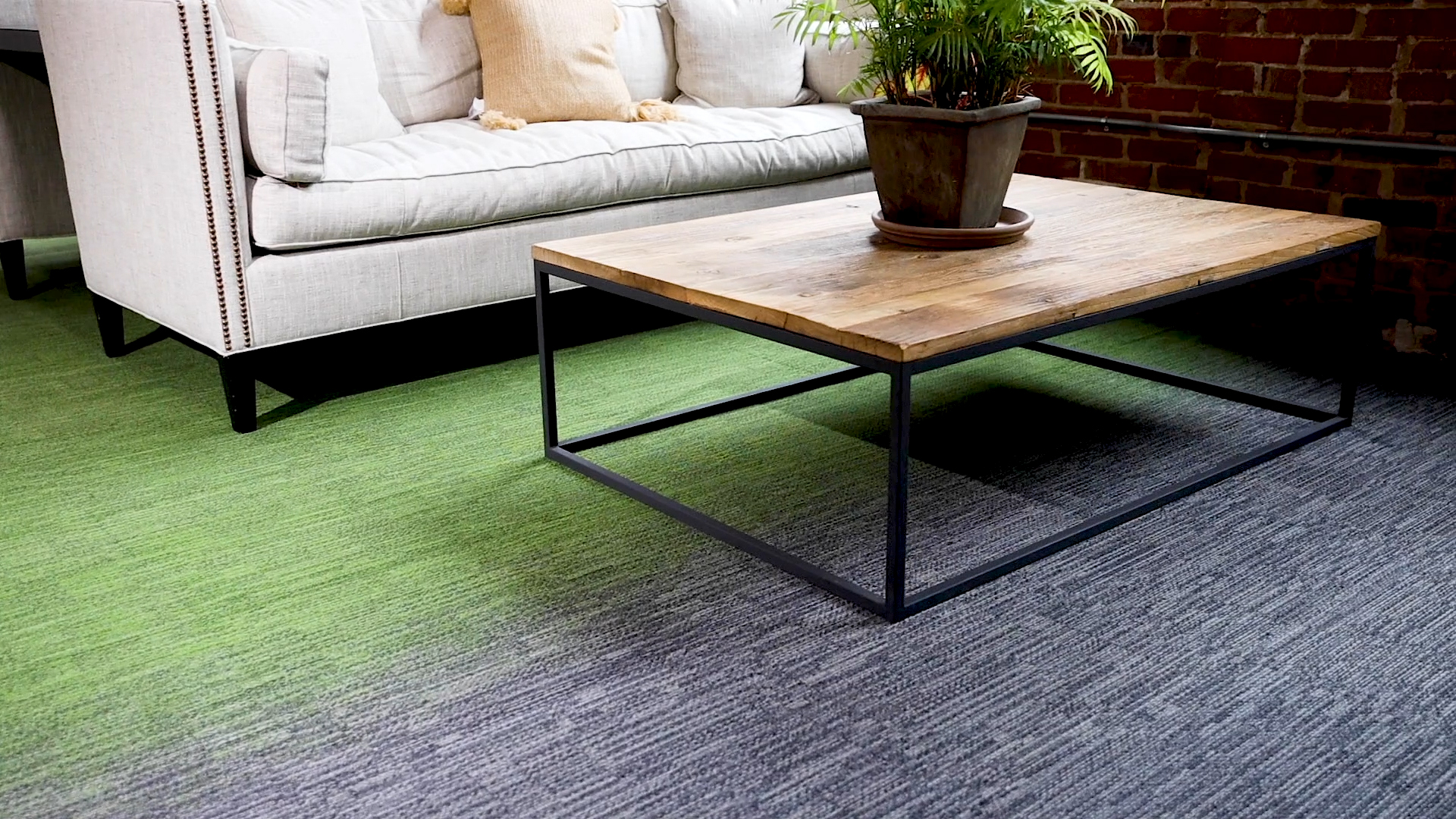 Laylines carpet tile installed in a lounge space with green-to-gray gradient flooring