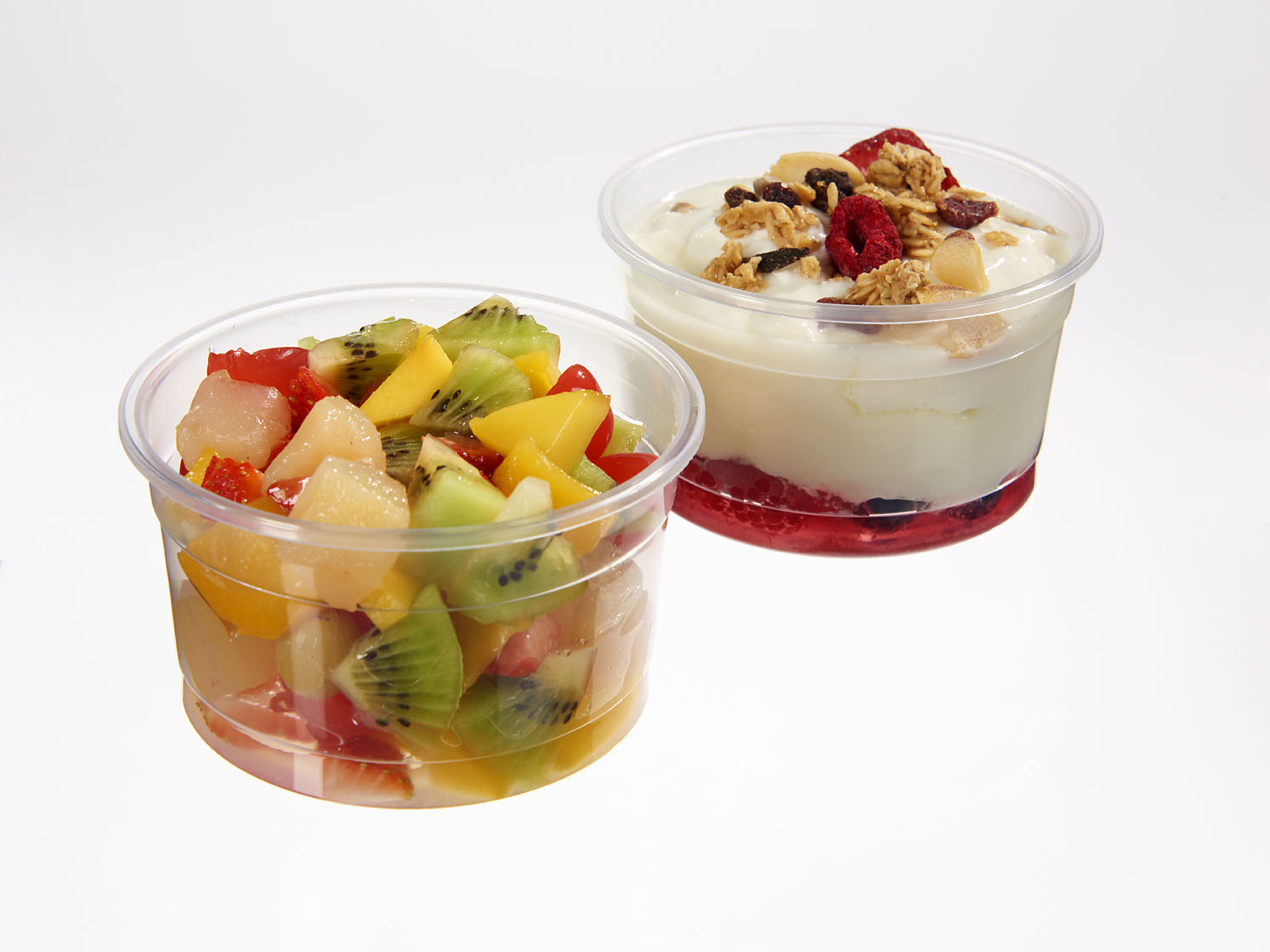 Two clear containers with fruit and yogurt inside
